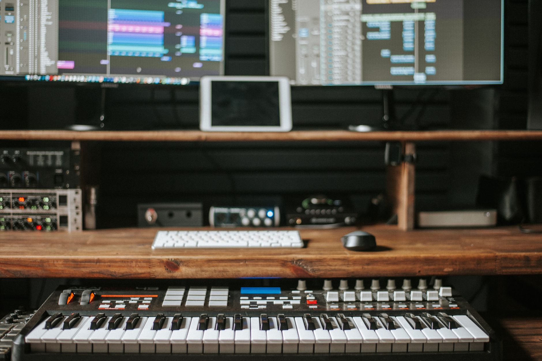 home studio desk setup with audio interface and condenser microphone