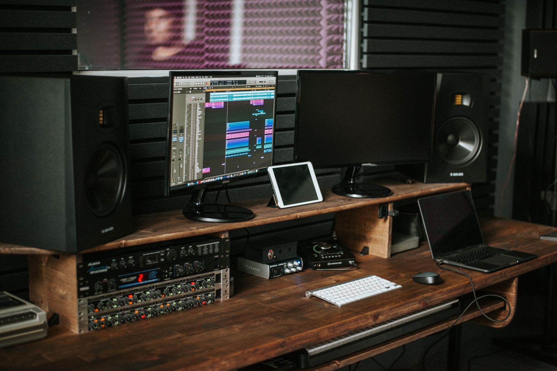 home recording studio corner setup with acoustic blanket treatment
