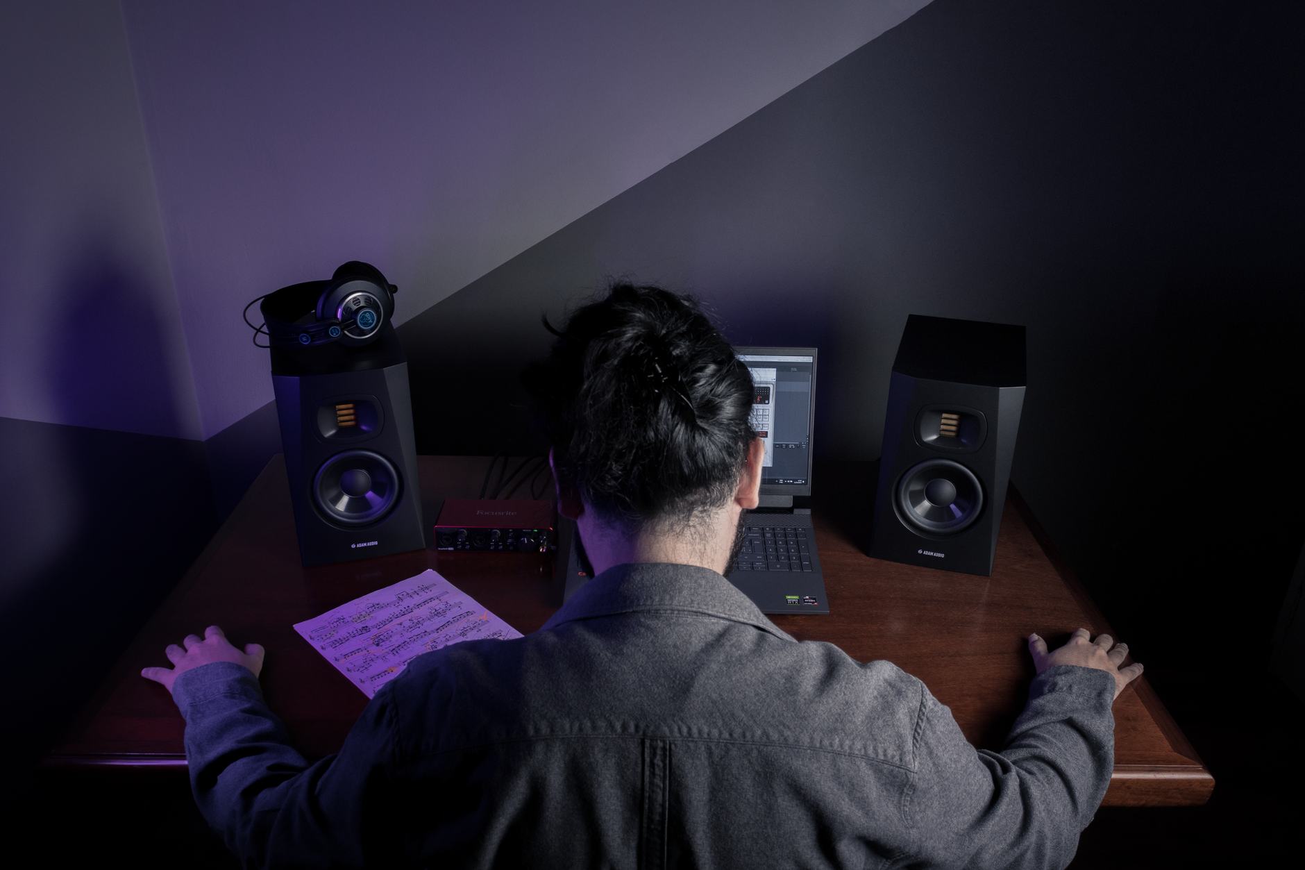 home studio desk setup with audio interface and headphones